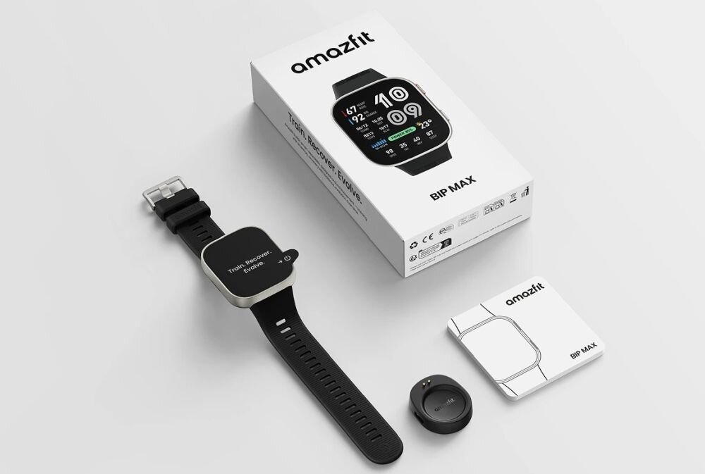 Na obrazie znajduje się smartwatch z czarnym paskiem, pudełko z napisem \'amazfit BIP MAX\', ładowarka oraz instrukcja obsługi. Na ekranie zegarka widoczne są różne wskaźniki i cyfry.