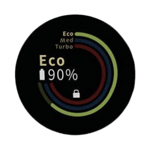 Na czarnym tle widoczny jest okrągły wskaźnik z kolorowymi łukami i tekstem \'Eco 90%\'. Obok znajduje się symbol kłódki oraz napisy \'Eco\', \'Med\', \'Turbo\'.