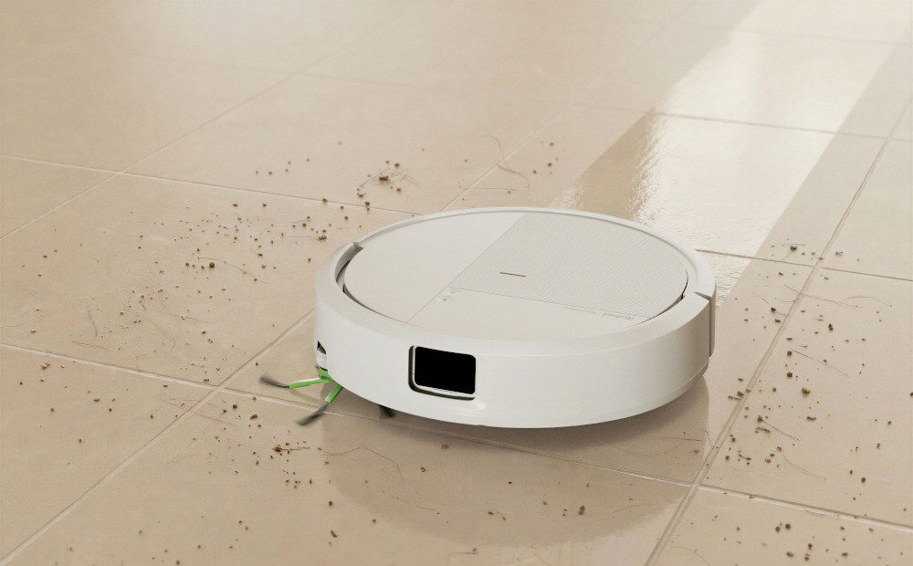 Biały robot sprzątający porusza się po podłodze, zbierając widoczne drobinki kurzu i brudu. Podłoga jest jasna i błyszcząca, a robot ma okrągły kształt.