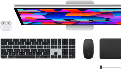 Na obrazie widoczny jest monitor z kolorowym, abstrakcyjnym wzorem na ekranie, klawiatura, mysz, touchpad oraz etui na słuchawki. Wszystkie elementy są w nowoczesnym stylu i utrzymane w ciemnej kolorystyce.