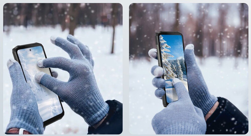 Osoba w rękawiczkach trzyma smartfon na tle zaśnieżonego krajobrazu. Na ekranie telefonu widoczne są zimowe sceny z drzewami pokrytymi śniegiem.