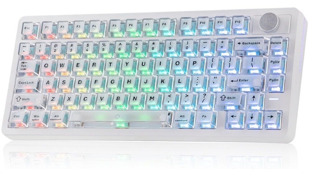 Biała klawiatura z podświetleniem RGB, posiada klawisze funkcyjne od F1 do F12 oraz pokrętło w prawym górnym rogu. Widoczne są klawisze takie jak Enter, Shift, Backspace, Delete, Caps Lock, Ctrl, Alt i Win.