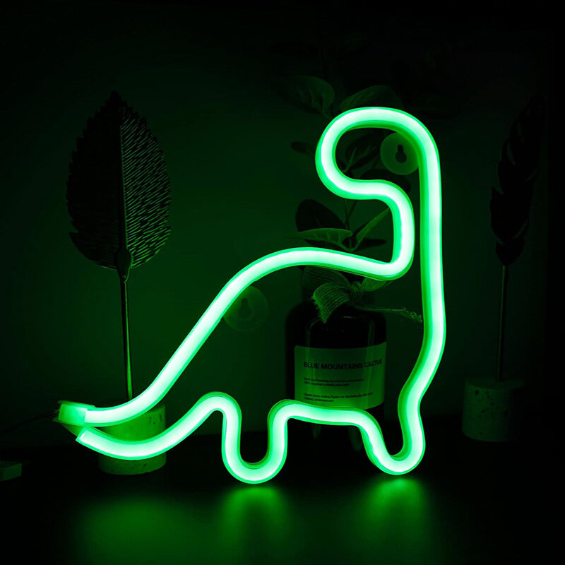 Neonowa lampka LED w kształcie dinozaura świeci jasnozielonym światłem. W tle widoczne są rośliny i butelka z napisem \'BLUE MOUNTAINS CACTUS\'.