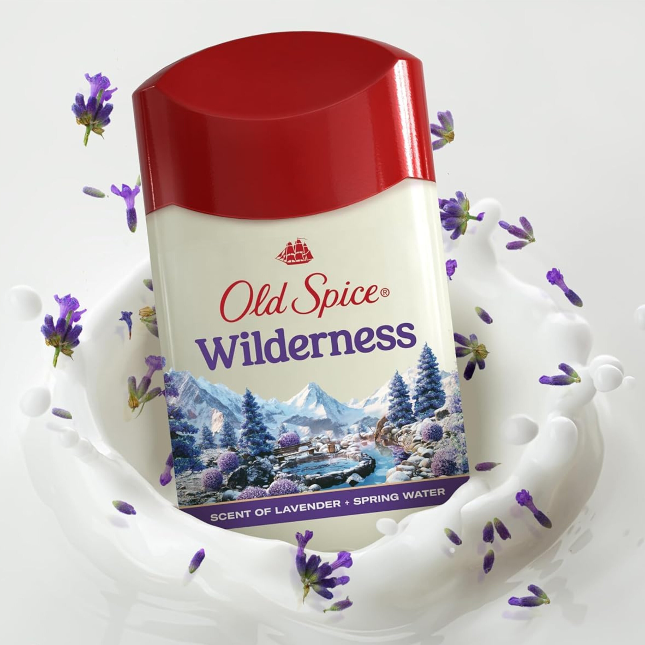Dezodorant w sztyfcie marki Old Spice o nazwie Wilderness, z grafiką przedstawiającą górski krajobraz. Widoczne są również lawendowe kwiaty i napis \'SCENT OF LAVENDER + SPRING WATER\'.