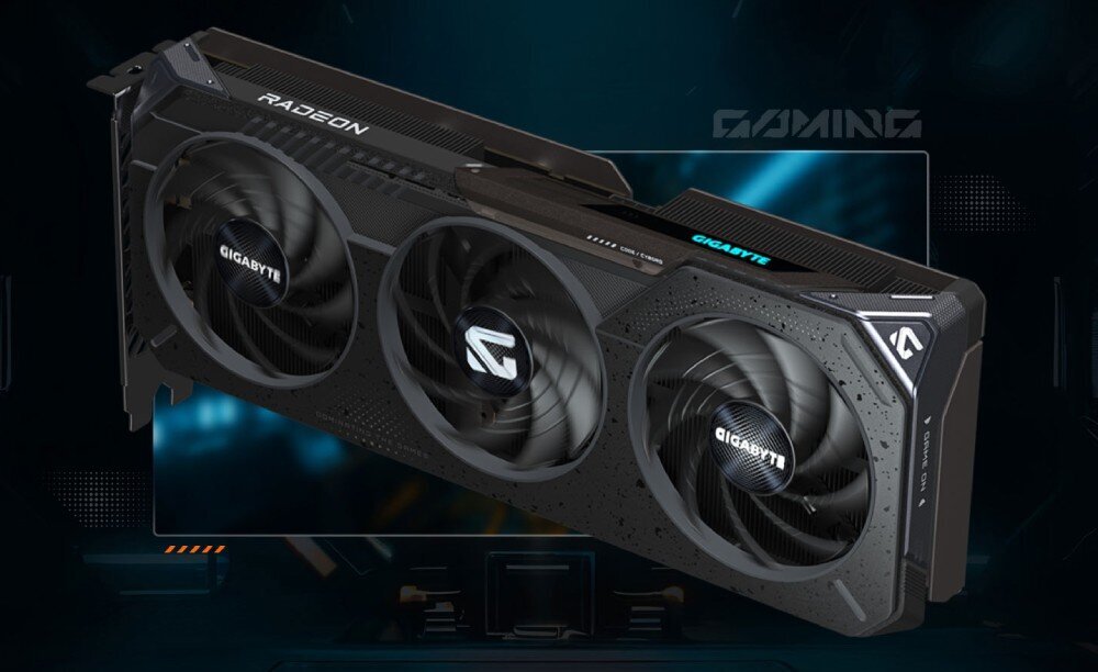 Karta graficzna z trzema wentylatorami, na której widoczne są napisy \'RADEON\' i \'GIGABYTE\'. W tle znajduje się ciemne, futurystyczne tło z elementami graficznymi i napisem \'GAMING\'.