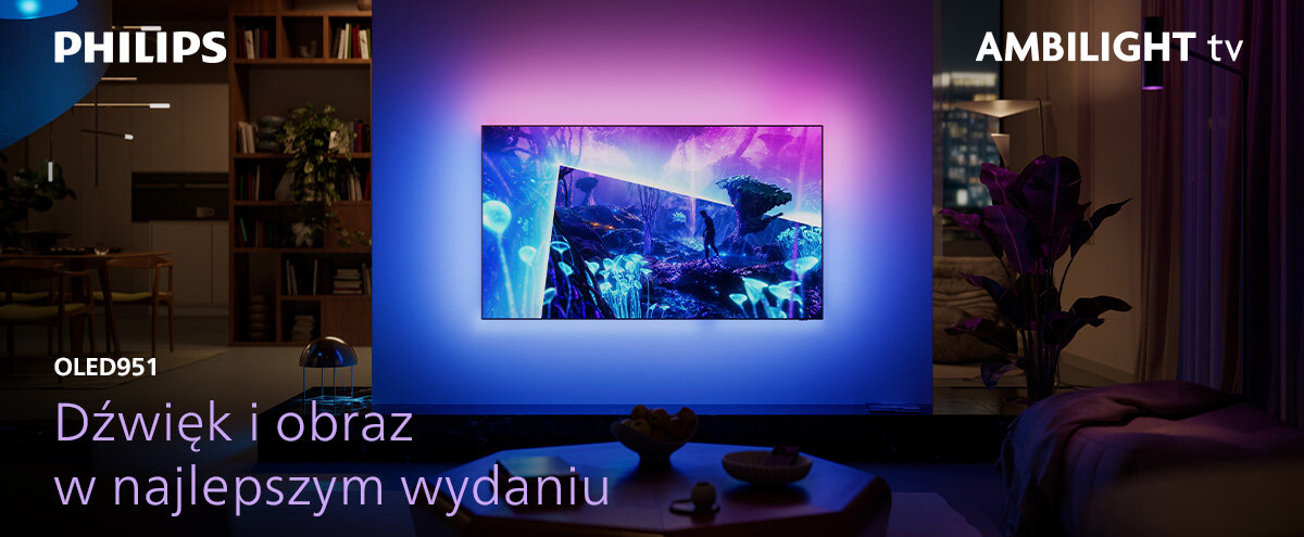 Telewizor wyświetla kolorowy obraz na ścianie w przyciemnionym pokoju. Widoczny tekst: \'PHILIPS\', \'AMBILIGHT tv\', \'OLED951\', \'Dźwięk i obraz w najlepszym wydaniu\'.