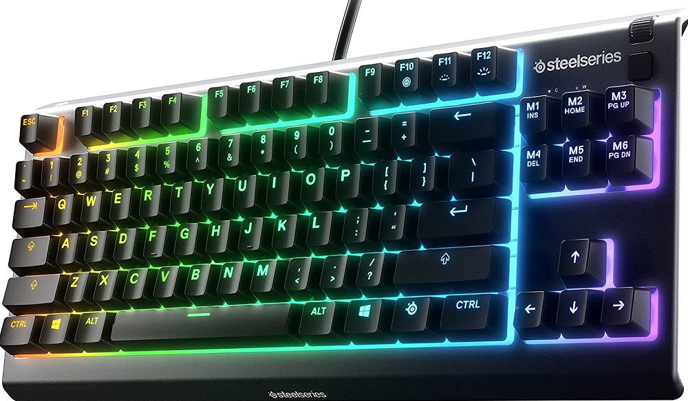 Klawiatura z podświetleniem RGB, widoczne klawisze funkcyjne F1-F12 oraz klawisze multimedialne M1-M6. Logo \'steelseries\' znajduje się w prawym górnym rogu.