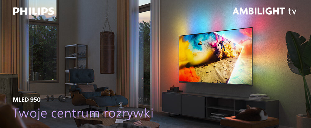 W salonie znajduje się duży telewizor na ścianie, emitujący kolorowe światło Ambilight. Na ekranie widoczny jest dynamiczny obraz, a w rogu znajduje się tekst: \'PHILIPS\', \'AMBILIGHT tv\', \'MLED 950\', \'Twoje centrum rozrywki\'.