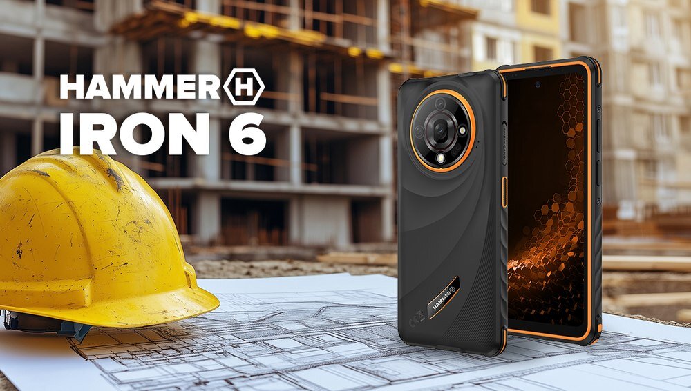 Na pierwszym planie znajduje się smartfon z dużym obiektywem aparatu i pomarańczowymi akcentami. Obok leży żółty kask ochronny, a w tle widać plac budowy oraz tekst \'HAMMER IRON 6\'.