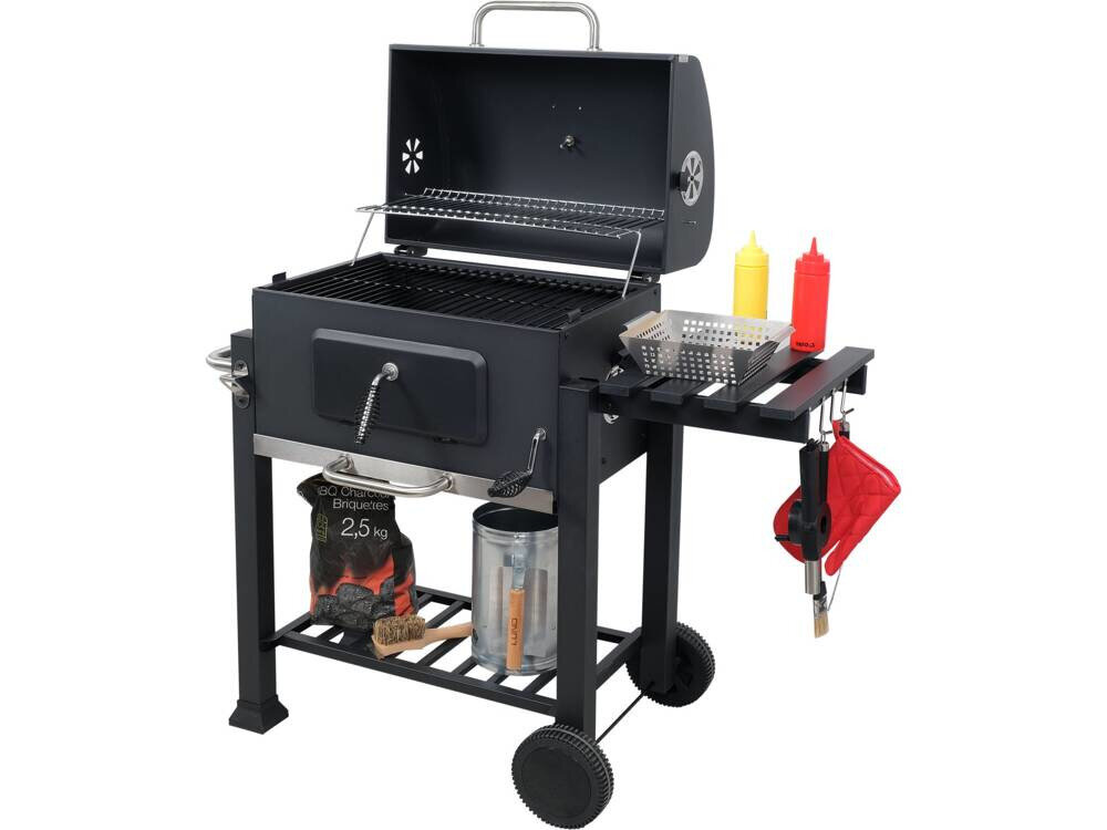 Grill węglowy z zamykaną pokrywą, półką boczną, termometrem i kółkami. Na półce bocznej znajdują się pojemniki na przyprawy i akcesoria do grillowania.