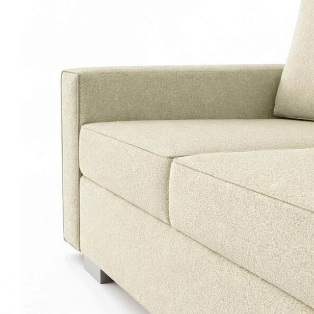 Obraz przedstawia kremową sofę z funkcją spania, z widocznym podłokietnikiem i siedziskiem. Sofa ma prosty, nowoczesny design z gładką tapicerką.