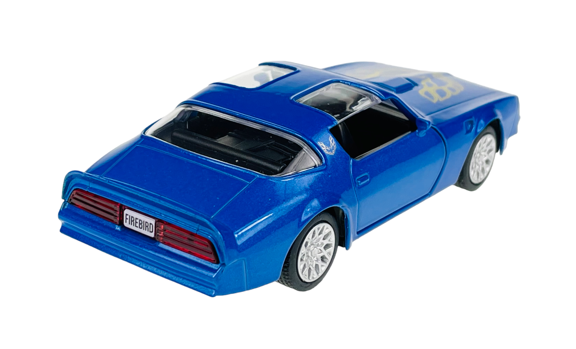 Niebieski model samochodu z otwartymi drzwiami i widocznym napisem \'FIREBIRD\' na tablicy rejestracyjnej. Na masce znajduje się żółty wzór.