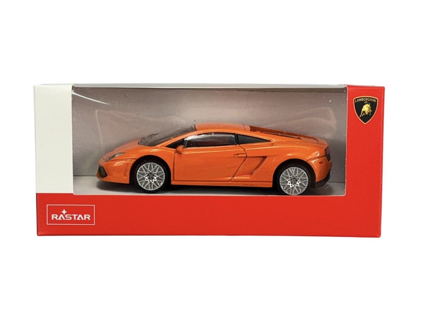 Model samochodu w kolorze pomarańczowym znajduje się w pudełku z przezroczystym frontem. Na pudełku widoczne są logo \'RASTAR\' oraz logo \'Lamborghini\'.