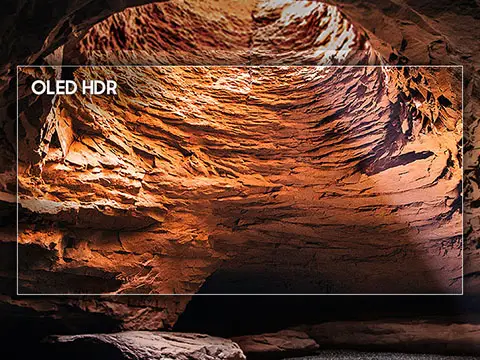 480x360-2025 picture quality oled hdr mo Obraz przedstawia wnętrze jaskini z wyraźnie widocznymi, pomarańczowymi skałami oświetlonymi światłem. Na obrazie znajduje się tekst \'OLED HDR\'.