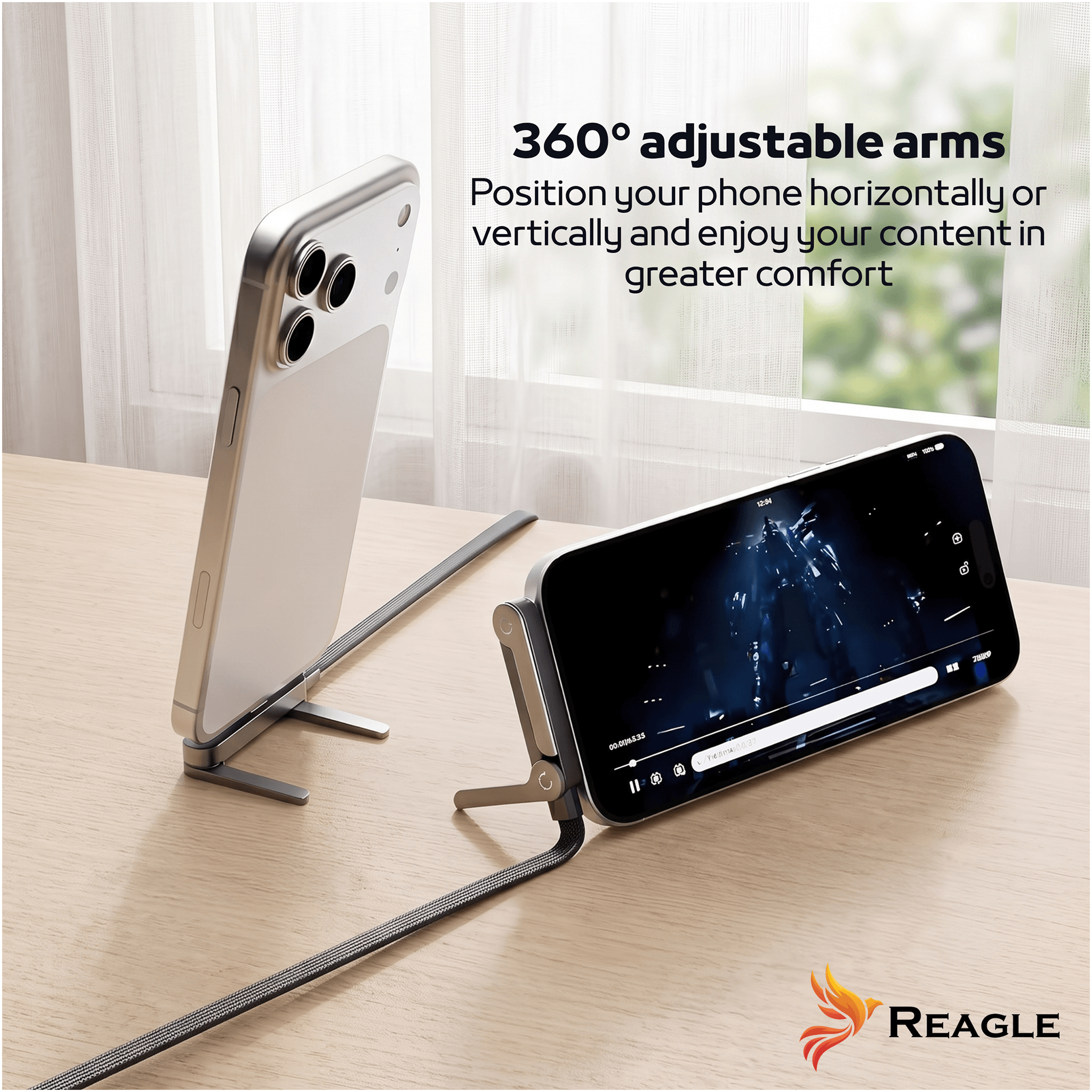 Dwa telefony umieszczone na stojakach, jeden w pozycji pionowej, drugi poziomej, na drewnianym blacie. Tekst na obrazie: \'360° adjustable arms Position your phone horizontally or vertically and enjoy your content in greater comfort\' oraz logo \'Reagle\'.