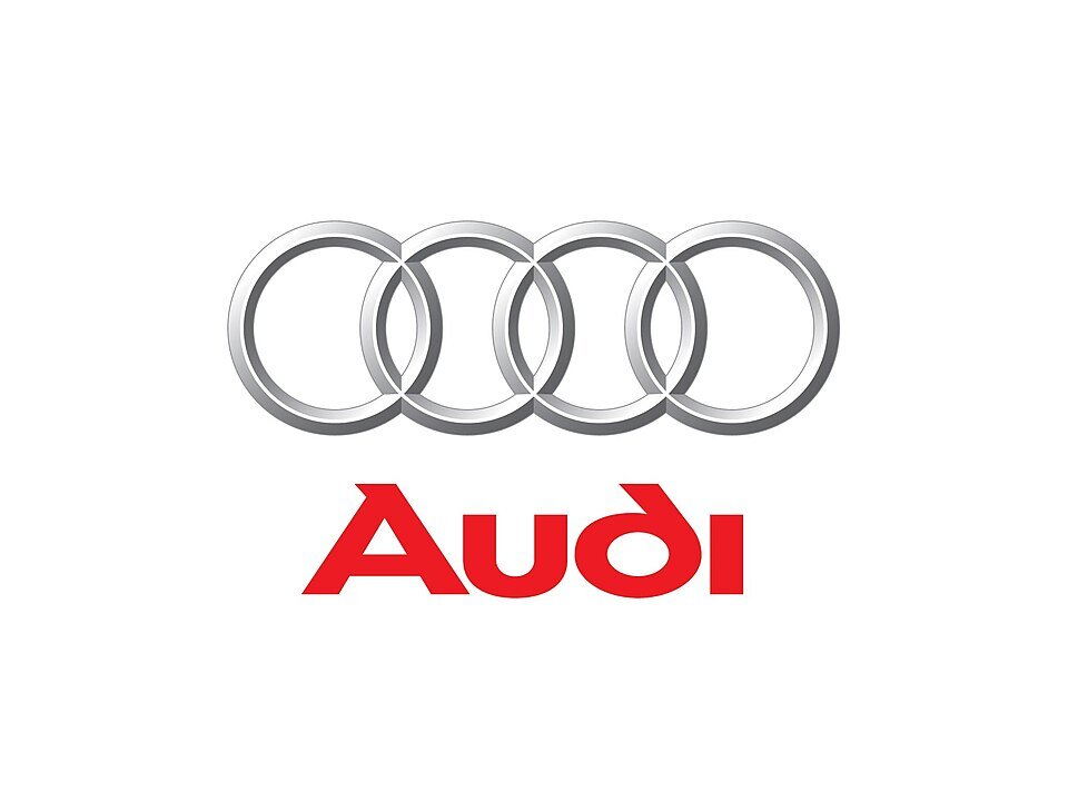 Logo składa się z czterech srebrnych, przeplatających się pierścieni z napisem \'Audi\' poniżej w czerwonym kolorze.