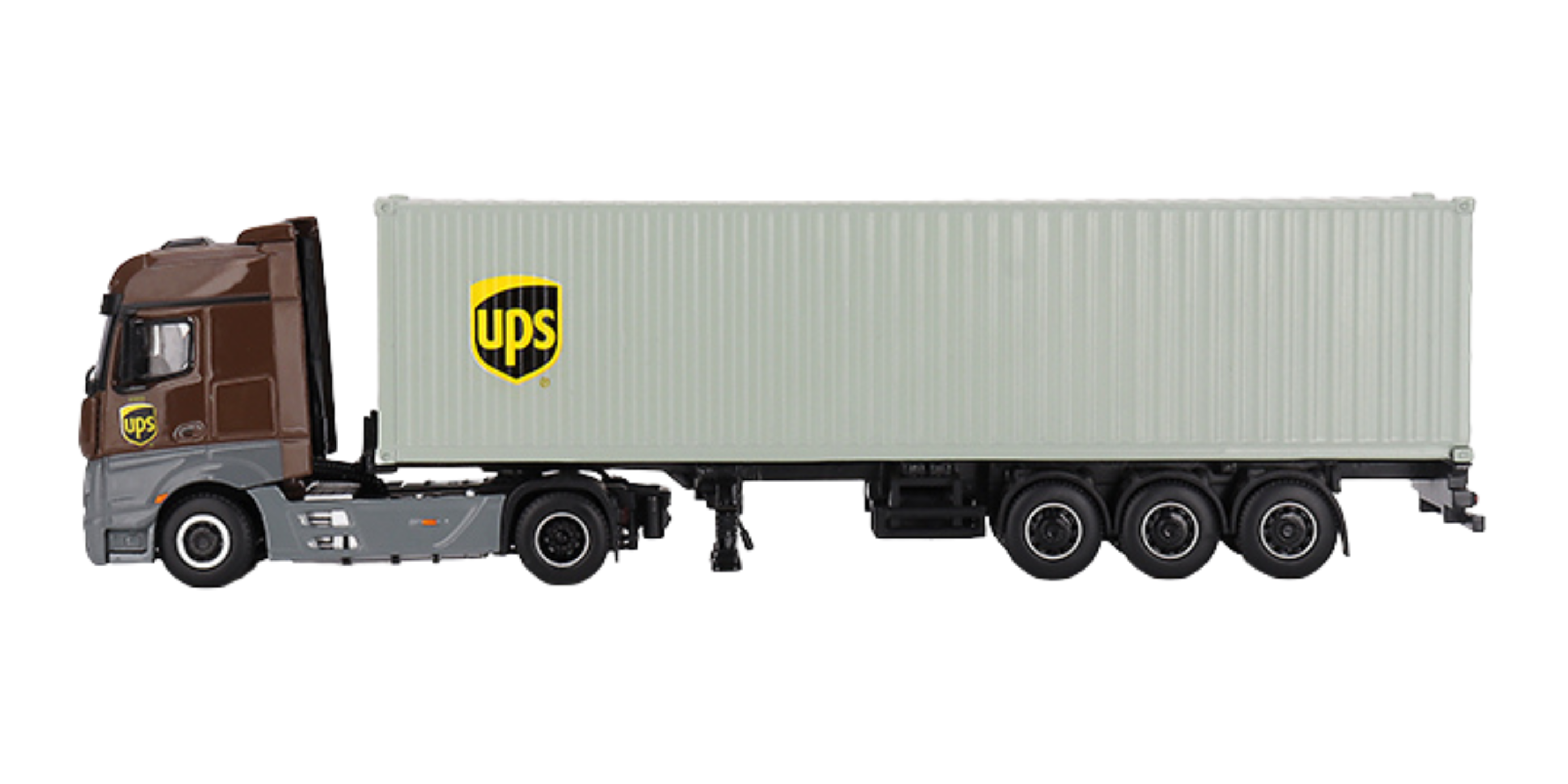 Model ciężarówki z naczepą w skali 1:64, przedstawiający Mercedes-Benz Actros z kontenerem w kolorze szarym i logo UPS na kabinie oraz kontenerze.