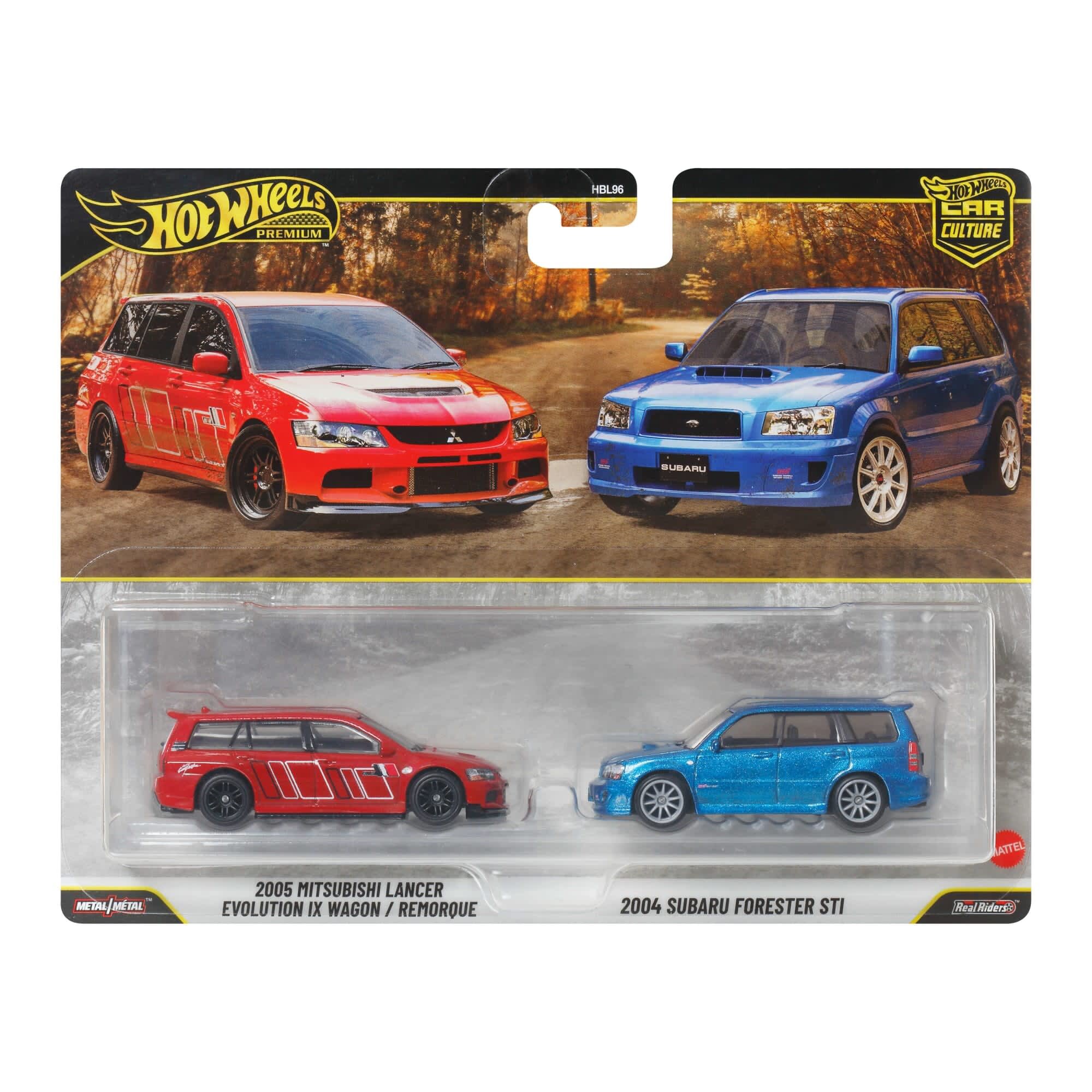 Opakowanie z dwoma modelami samochodów w skali 1:64, czerwonym Mitsubishi Lancer Evolution IX Wagon i niebieskim Subaru Forester STI. Na opakowaniu widnieje logo \'Hot Wheels\' oraz napisy \'2005 Mitsubishi Lancer Evolution IX Wagon\' i \'2004 Subaru Forester STI\'.