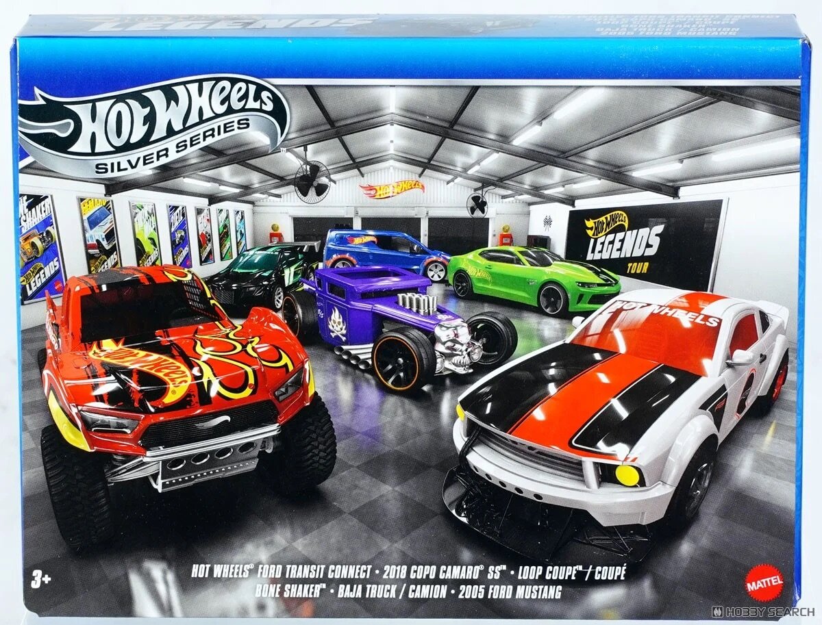 Obraz przedstawia sześć metalowych modeli samochodów Hot Wheels w różnych kolorach, ustawionych w rzędzie w pomieszczeniu przypominającym garaż. Na górze widnieje napis \'Hot Wheels Silver Series\', a na dole wymienione są modele: \'Ford Transit Connect\', \'2018 Copo Camaro SS\', \'Loop Coupe\', \'Bone Shaker\', \'Baja Truck\', \'2005 Ford Mustang\'.