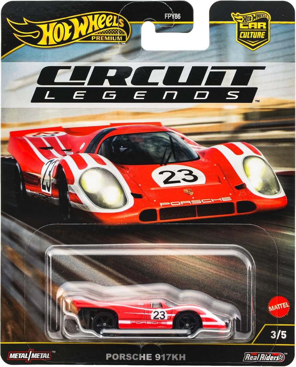Opakowanie z modelem samochodu Hot Wheels Porsche 917KH z serii Circuit Legends. Widoczny czerwony samochód z numerem 23 oraz logo Porsche, a na opakowaniu napisy: \'Hot Wheels Premium\', \'Circuit Legends\', \'Metal/Metal\', \'Real Riders\', \'Mattel\'.