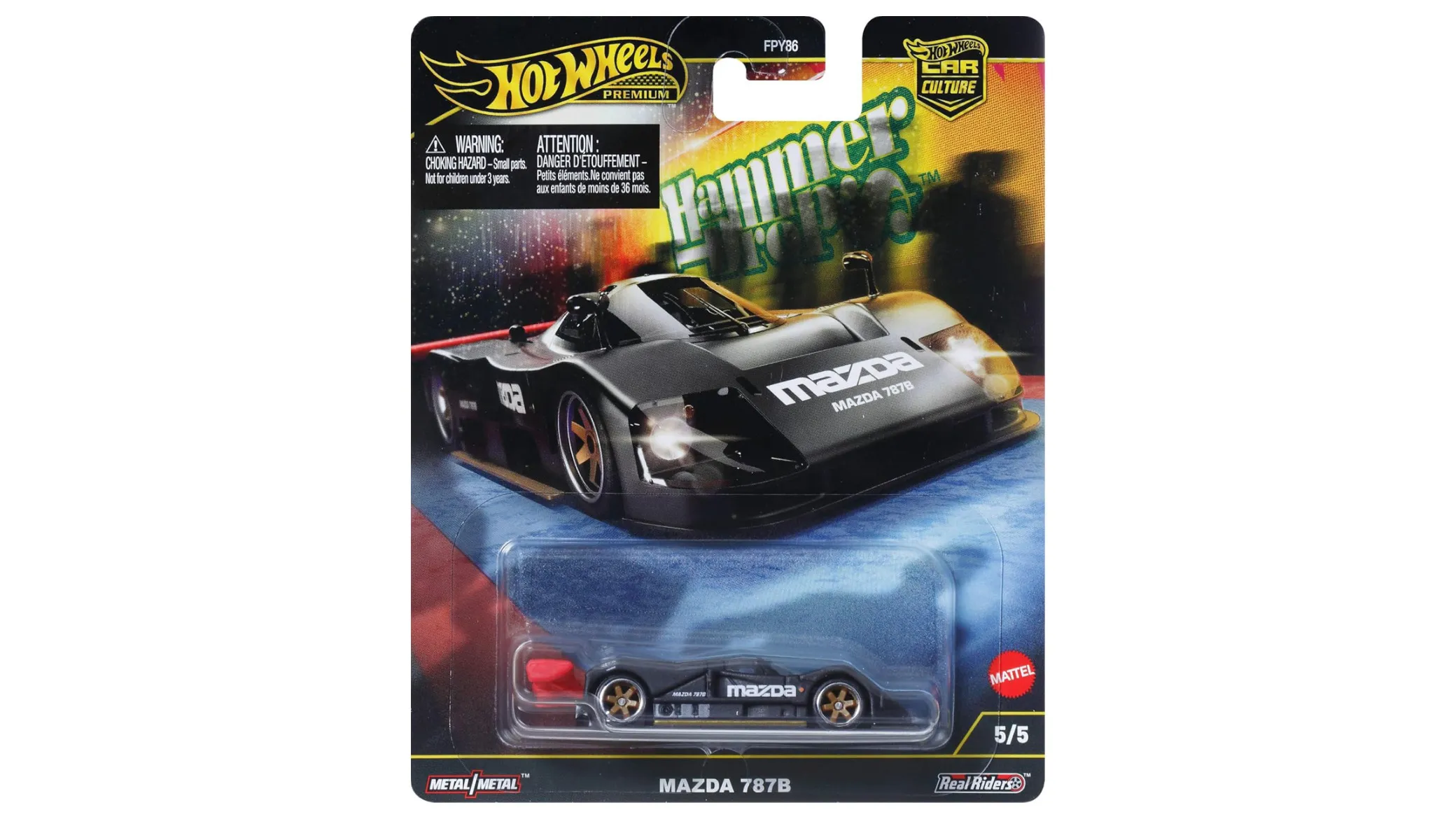 Opakowanie z modelem samochodu Hot Wheels Premium, przedstawiające czarny samochód wyścigowy z napisem \'MAZDA 787B\'. Widoczne są logotypy \'Hot Wheels\', \'Car Culture\', \'Metal/Metal\' oraz \'Real Riders\'.