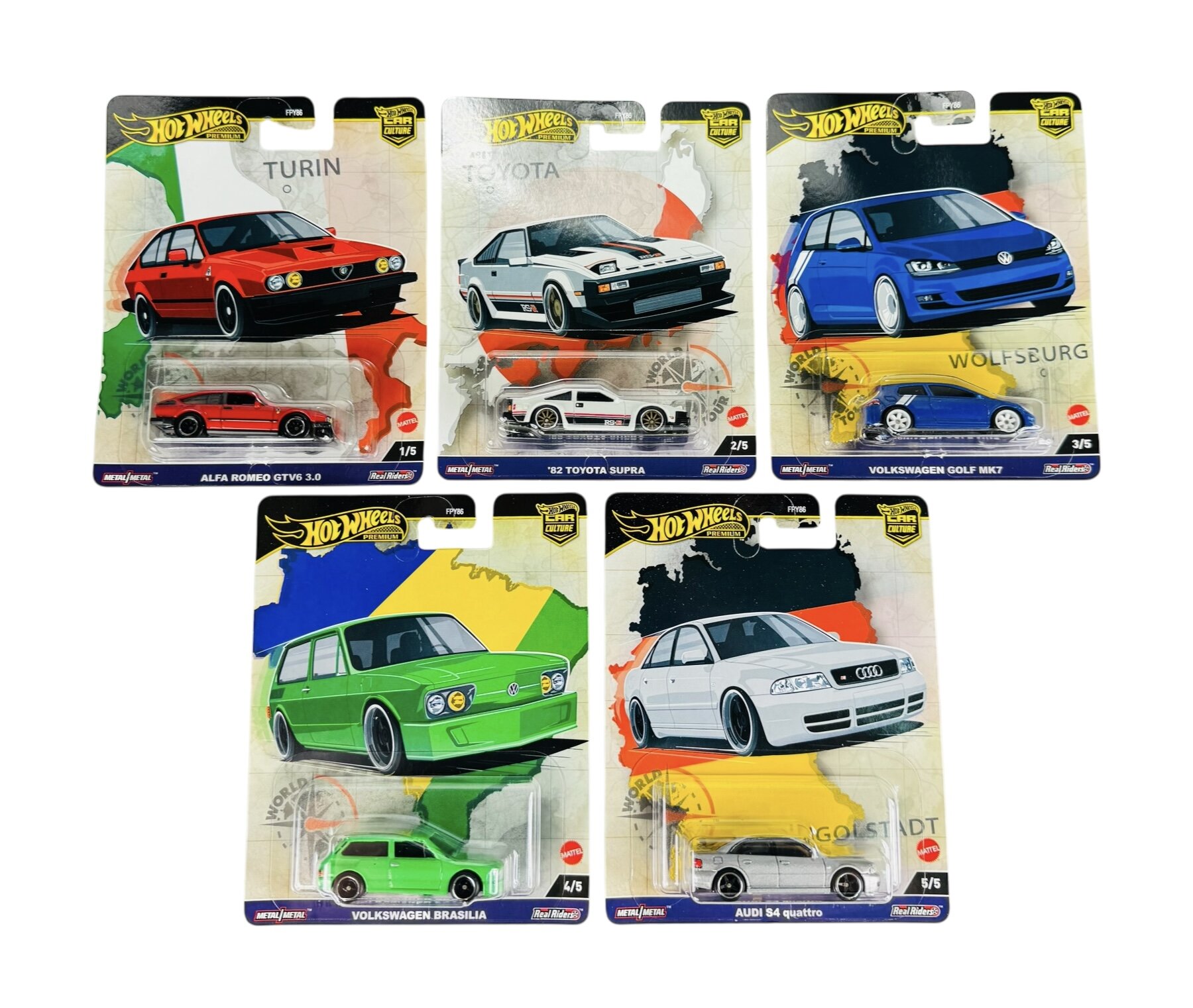 Zdjęcie przedstawia pięć opakowań modeli samochodów Hot Wheels Premium World Tour. Każde opakowanie zawiera metalowy model samochodu oraz grafikę z nazwą miasta i marki pojazdu: Alfa Romeo GTV6 3.0, \'82 Toyota Supra, Volkswagen Golf MK7, Volkswagen Brasilia, Audi S4 quattro.