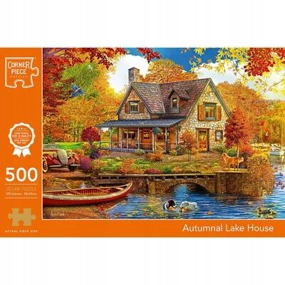 Obrazek przedstawia pudełko puzzli z ilustracją jesiennego domku nad jeziorem, otoczonego kolorowymi drzewami i łódką na wodzie. Na opakowaniu widnieje napis \'500\', \'Autumnal Lake House\' oraz logo \'Corner Piece\'.