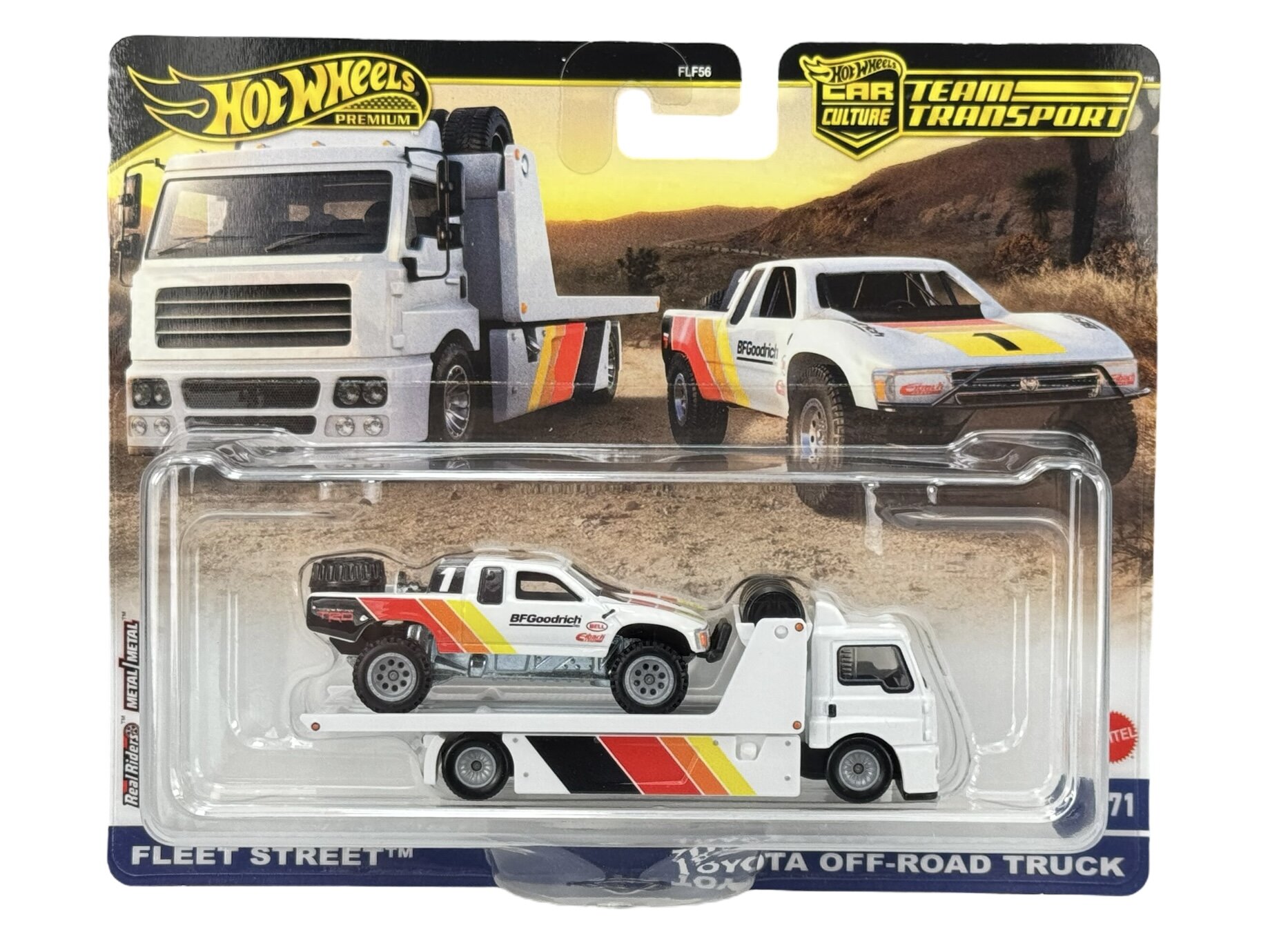 Opakowanie z modelem samochodu Hot Wheels Premium, przedstawiające białą ciężarówkę z kolorowymi paskami i napisem \'BFGoodrich\'. W tle widoczne są ilustracje dwóch pojazdów terenowych na pustynnym krajobrazie.