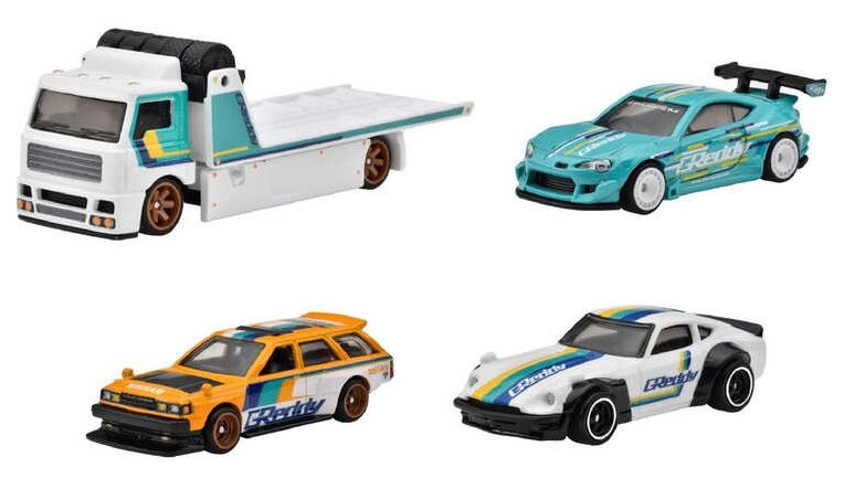 Na obrazie widoczne są cztery metalowe modele samochodów w różnych kolorach i stylach, z logo \'Greddy\' na bokach. Modele obejmują lawetę, sportowy samochód w kolorze turkusowym, pomarańczowe kombi oraz biały samochód sportowy.
