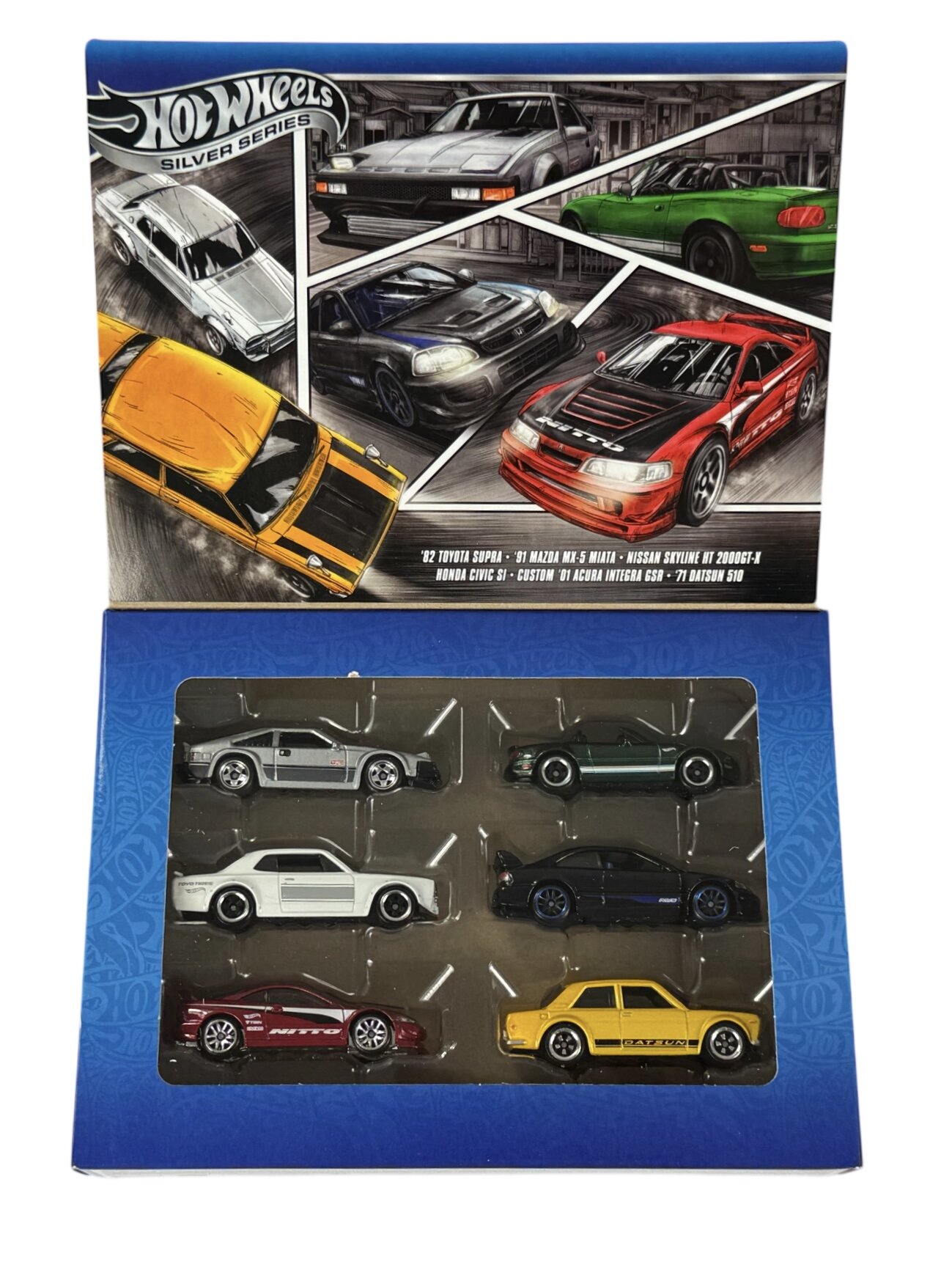 Zestaw sześciu metalowych modeli samochodów Hot Wheels w opakowaniu z grafiką przedstawiającą różne samochody. Na opakowaniu widnieje napis: \'Hot Wheels Silver Series\' oraz lista modeli: \'82 Toyota Supra, \'91 Mazda MX-5 Miata, Nissan Skyline HT 2000GT-X, Honda Civic Si, Custom \'01 Acura Integra GSR, \'71 Datsun 510\'.