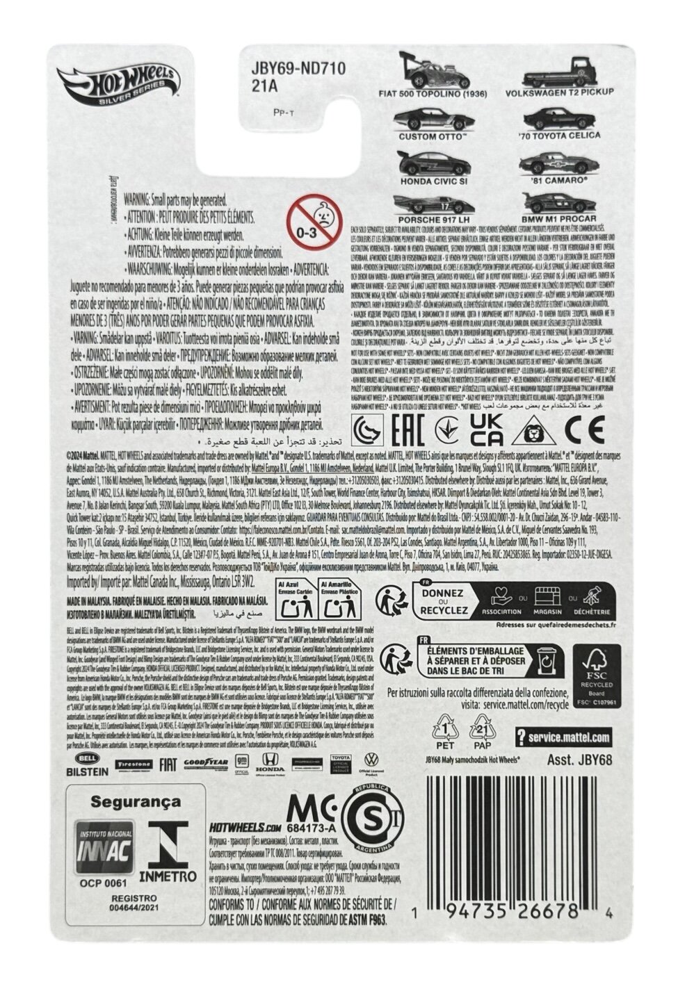Opakowanie produktu Hot Wheels z widocznym logo i numerem JBY69-ND710 21A. Zawiera ostrzeżenia w kilku językach oraz symbole certyfikacji i recyklingu.