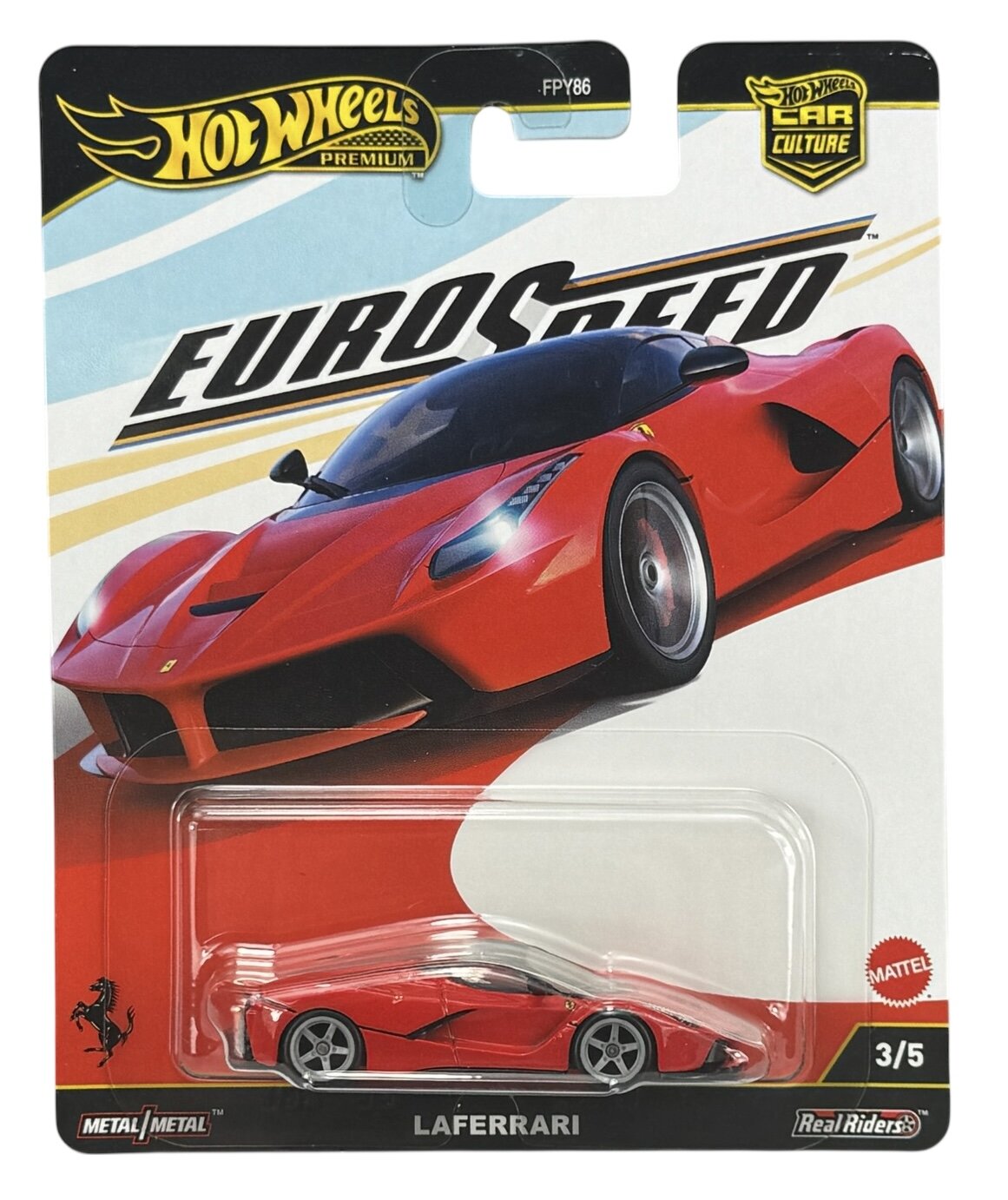 Opakowanie z modelem samochodu Hot Wheels Premium Eurospeed, przedstawiające czerwony samochód LaFerrari. Widoczne napisy to \'Hot Wheels Premium\', \'Eurospeed\', \'LaFerrari\', \'Metal/Metal\', \'Real Riders\', \'FPY86\', oraz logo Mattel.