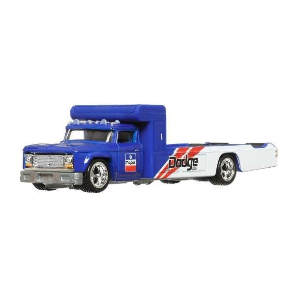 Model samochodu ciężarowego w kolorze niebieskim z białą naczepą, na której widnieje napis \'Dodge\'. Na drzwiach kabiny znajduje się logo \'mopar\'.