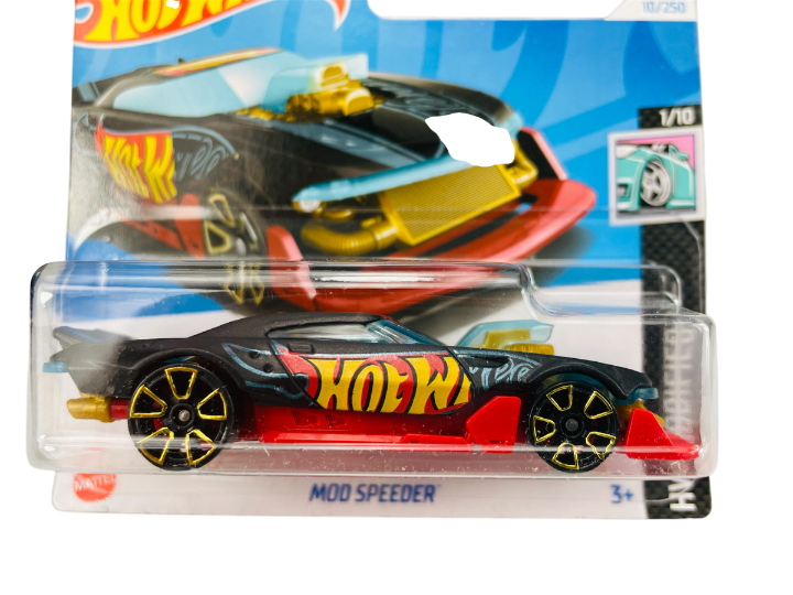 Opakowanie z modelem samochodu Hot Wheels o nazwie \'Mod Speeder\', z widocznym logo \'Hot Wheels\' na pojeździe. Samochód ma czarną karoserię z czerwonymi i żółtymi elementami oraz złote felgi.