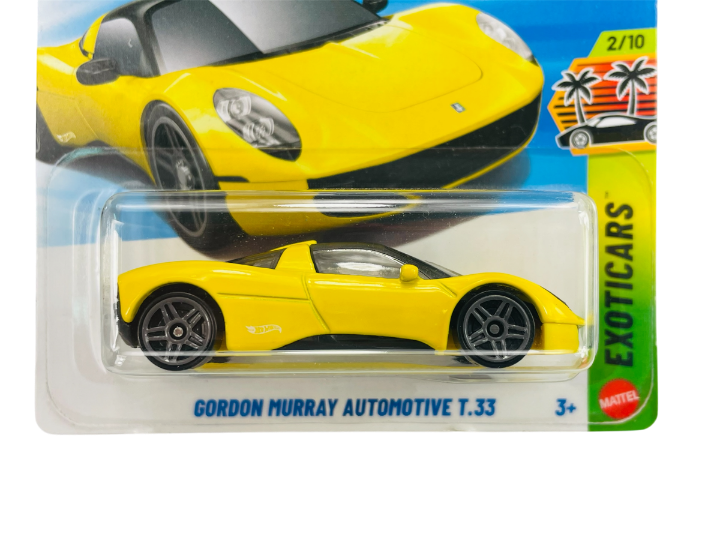 Opakowanie z metalowym modelem samochodu w żółtym kolorze, oznaczone jako \'Gordon Murray Automotive T.33\'. Widoczne są napisy \'EXOTICARS\', \'2/10\' oraz logo \'Mattel\'.