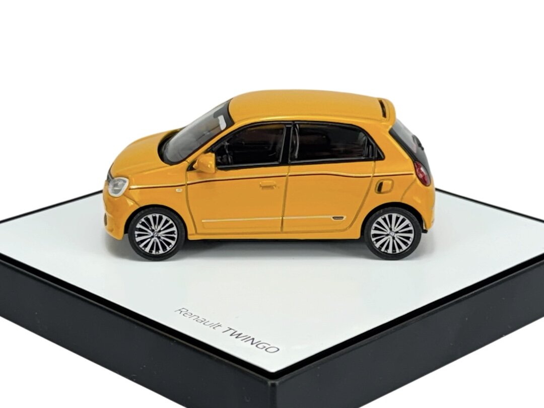 Model samochodu w kolorze żółtym na podstawce z napisem \'Renault TWINGO\'.