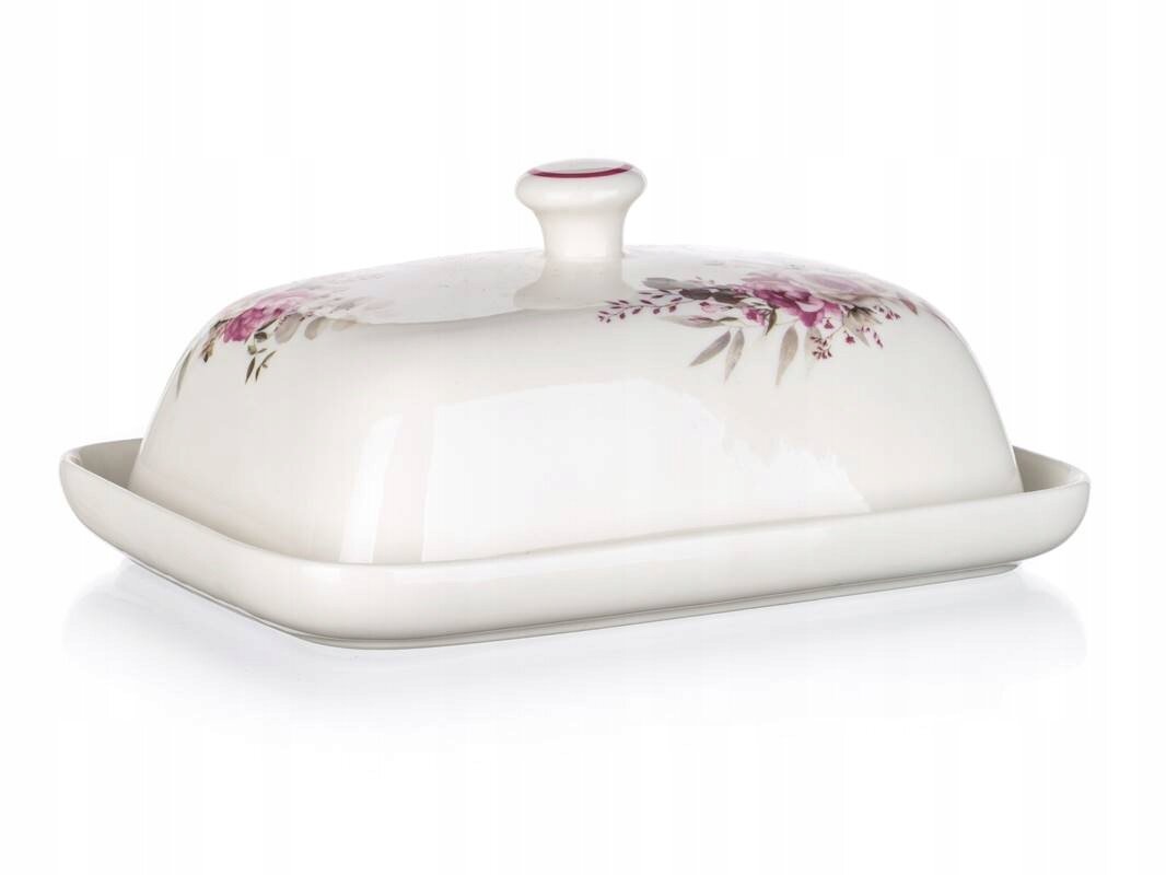 Ceramiczna maselniczka z pokrywką ozdobioną różowymi kwiatami i liśćmi. Pokrywka ma uchwyt na górze, a całość jest w jasnym kolorze.