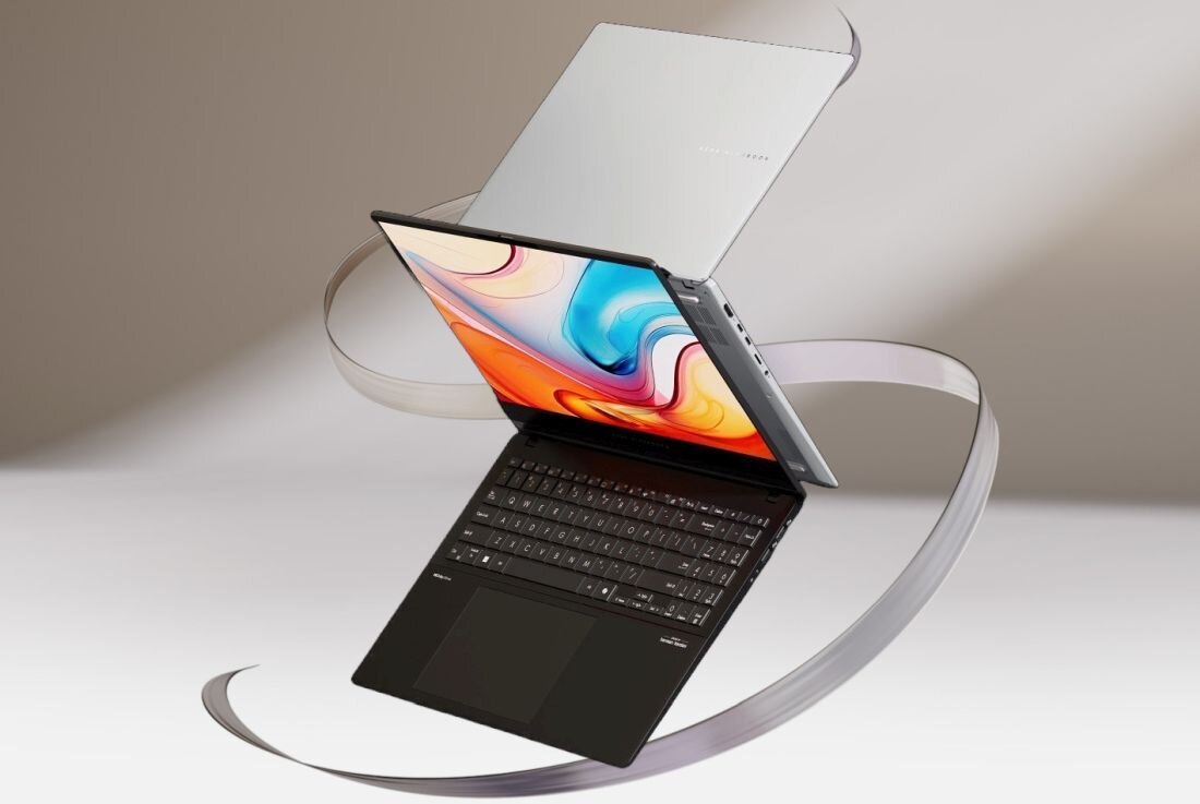 Laptop z otwartym ekranem i widoczną klawiaturą, na ekranie kolorowa grafika. Na obudowie widoczne logo producenta.