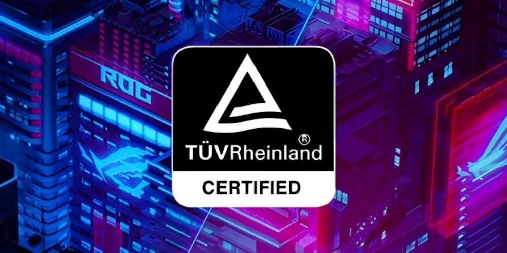 Obraz przedstawia neonowe budynki z logo \'ROG\' oraz znak TÜV Rheinland Certified na pierwszym planie. Tło jest w kolorach niebieskim i różowym.