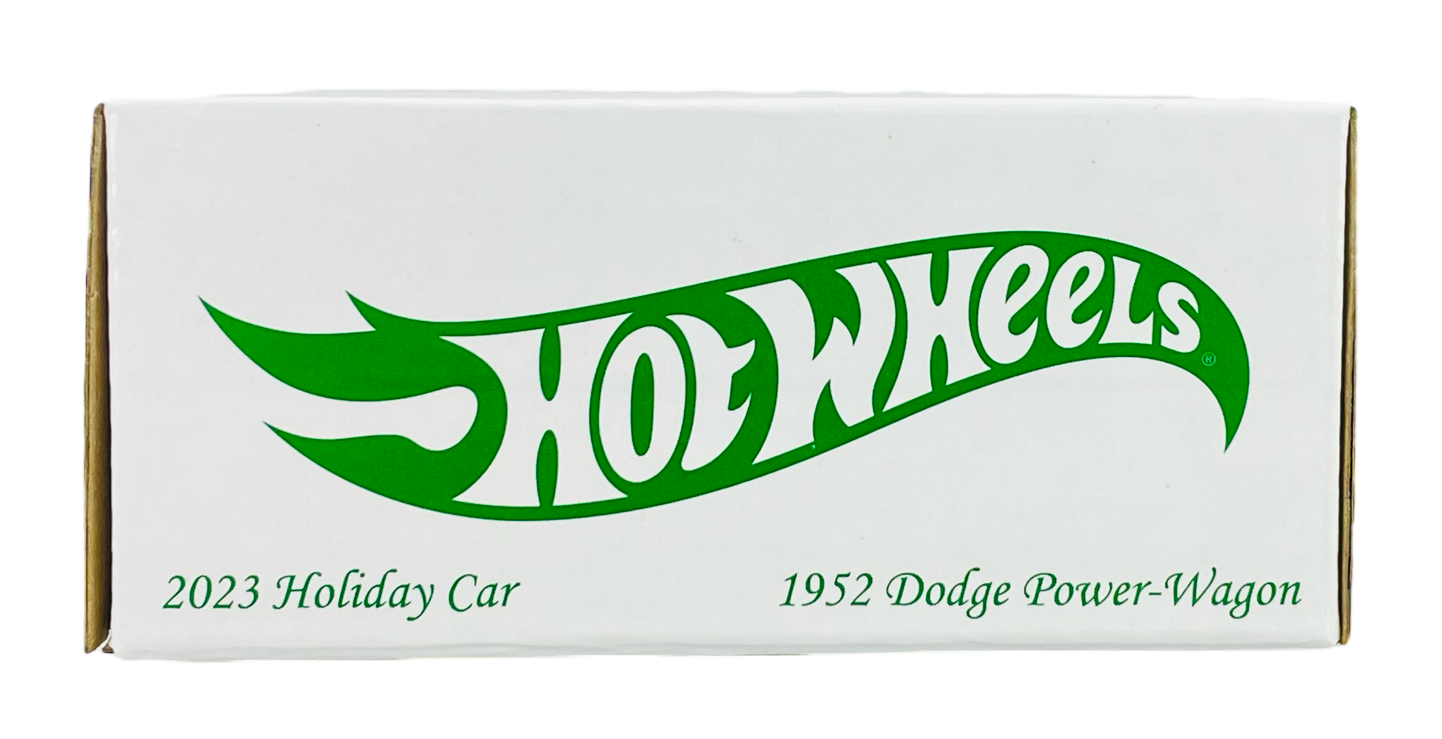 Białe pudełko z zielonym logo \'Hot Wheels\'. Na dole widnieje tekst: \'2023 Holiday Car 1952 Dodge Power-Wagon\'.