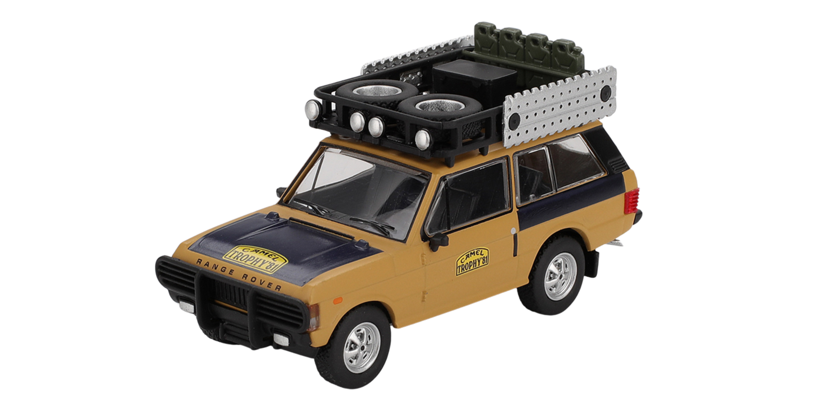 Model samochodu terenowego w kolorze żółtym z czarnymi elementami, z napisem \'Camel Trophy\' na masce i drzwiach. Na dachu znajduje się bagażnik z dodatkowymi kołami i reflektorami.
