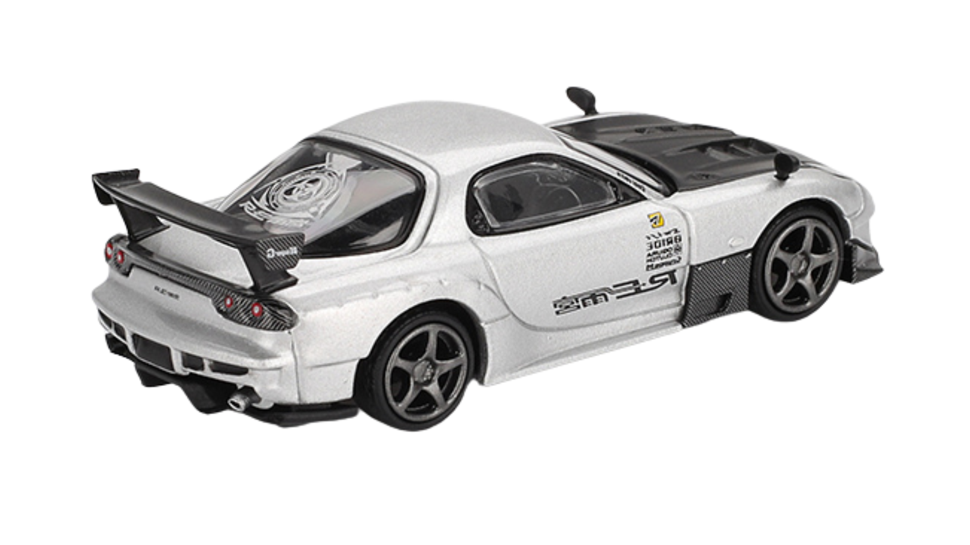 Model samochodu w skali 1:64 przedstawiający srebrny pojazd sportowy z dużym tylnym spojlerem i czarnymi detalami na masce. Na boku widoczne są napisy i logo, a na tylnej szybie znajduje się okrągły wzór.