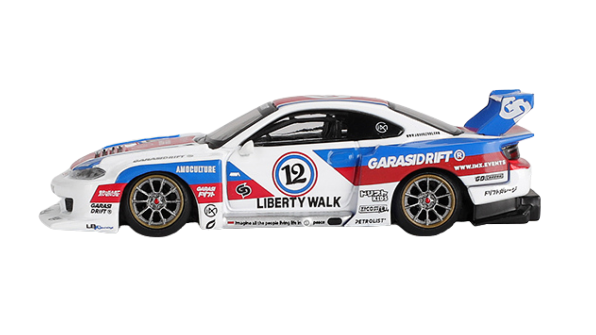 Model samochodu wyścigowego w skali 1:64, w kolorze białym z niebieskimi i czerwonymi akcentami, z widocznymi napisami \'LIBERTY WALK\' i \'GARASIDRIFT\'.