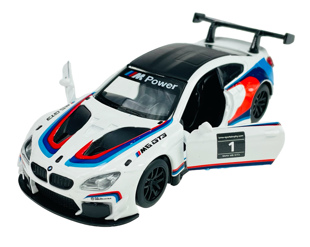 Model samochodu wyścigowego BMW M6 GT3 w skali 1:44, w kolorze białym z otwartymi drzwiami i widocznymi napisami \'M Power\' oraz \'M6 GT3\'. Samochód ma czarne felgi i kolorowe pasy na karoserii.