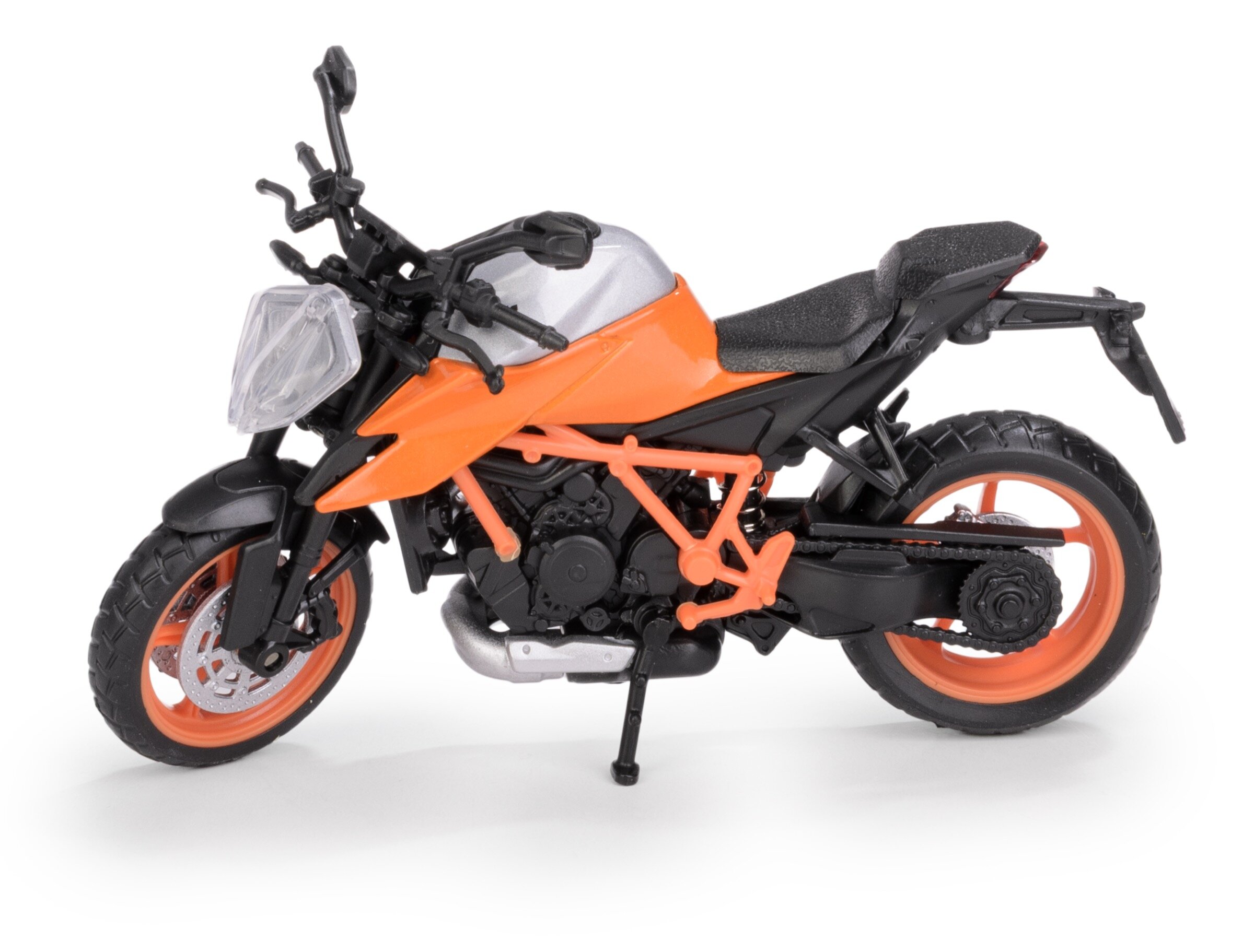 Model metalowy motocykla w kolorze pomarańczowym z czarnymi elementami, przedstawiony na białym tle. Motocykl posiada szczegółowe elementy, takie jak kierownica, siedzenie i koła.