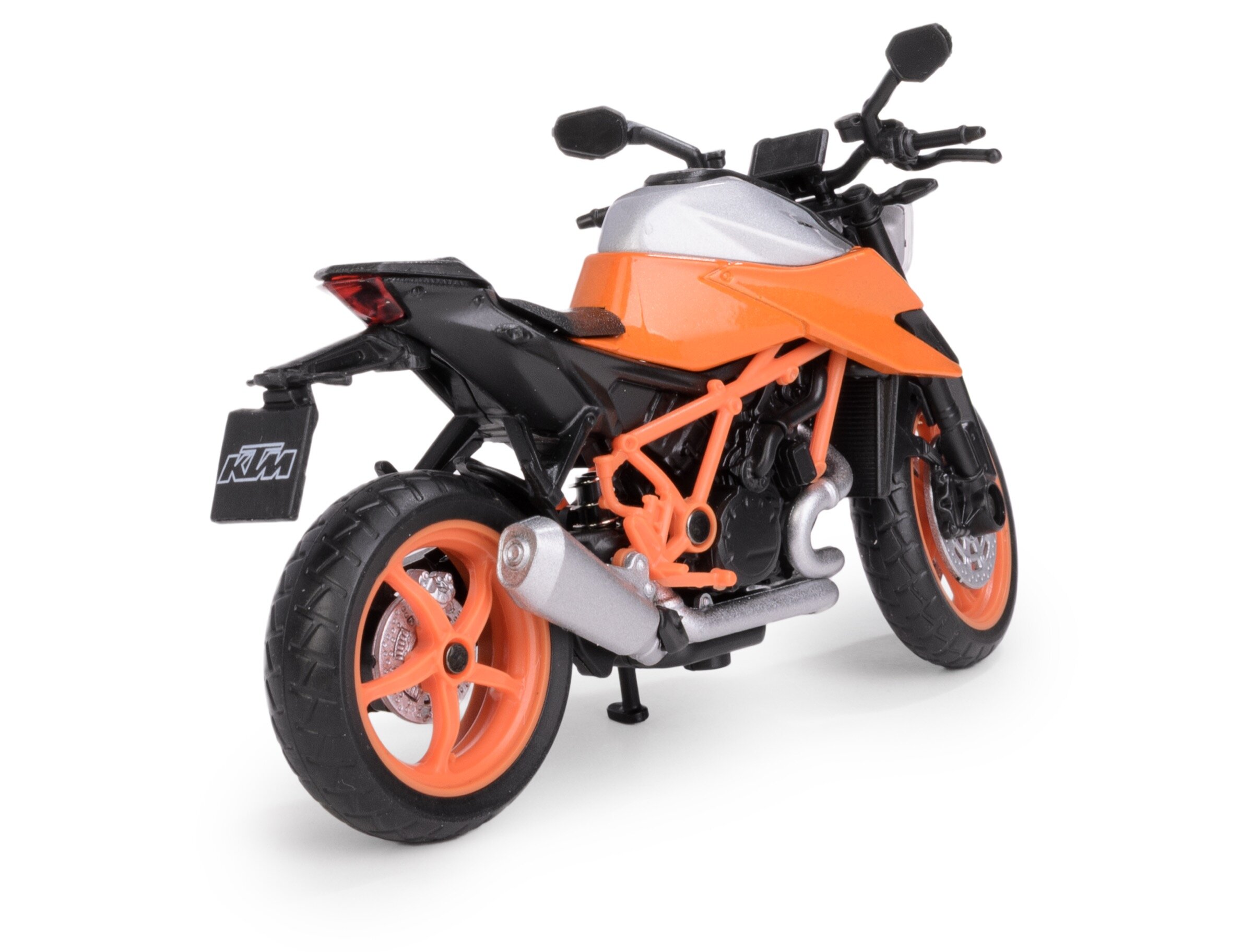 Model metalowy motocykla w kolorze pomarańczowym z czarnymi i srebrnymi elementami, widoczny z tyłu. Na tablicy rejestracyjnej znajduje się logo \'KTM\'.