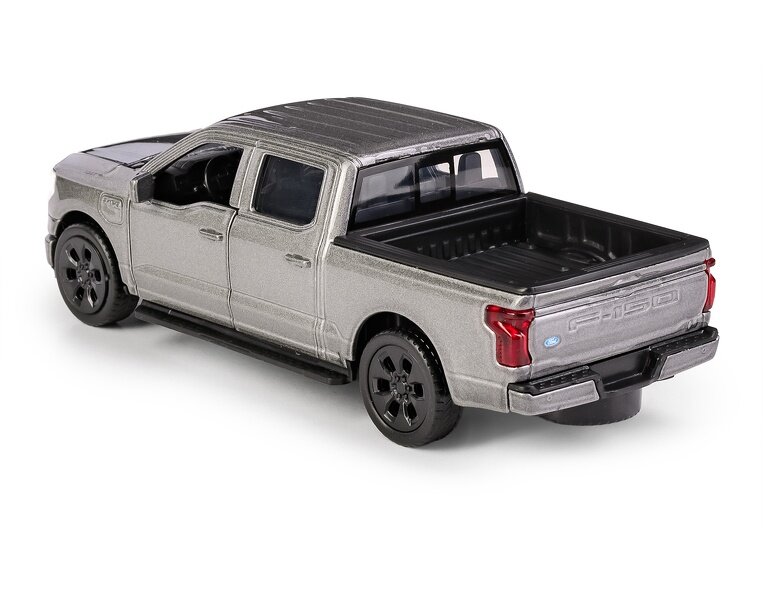 Model szarego samochodu typu pickup z czarnymi kołami i otwartą przestrzenią ładunkową. Na tylnej klapie widoczne jest logo \'F-150\'.