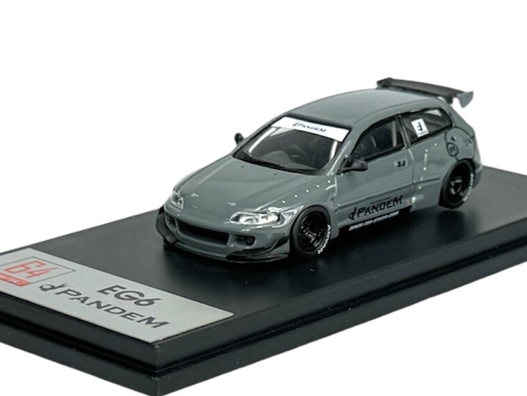Model samochodu w skali 1:64 w kolorze szarym, z napisem \'Pandem\' na boku. Na podstawce widnieje napis \'EG6 Pandem\'.