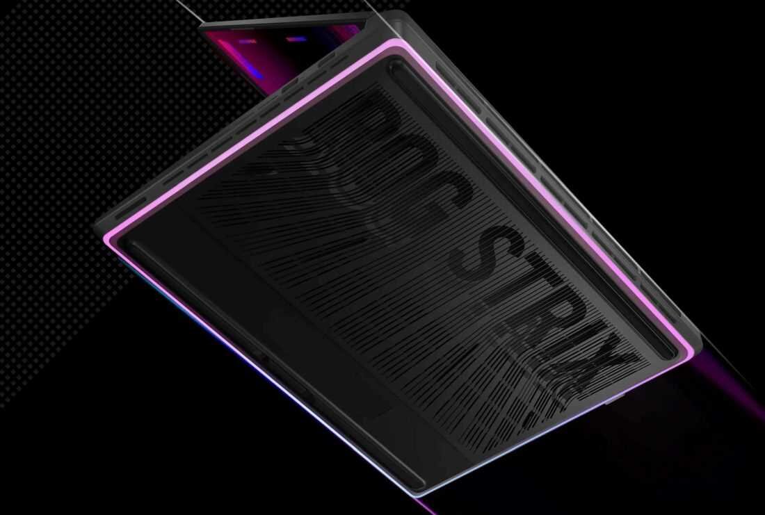 Obraz przedstawia laptop z widocznym napisem \'ROG STRIX\' na obudowie, otoczony podświetleniem LED w kolorze różowym. Tło jest czarne, co podkreśla nowoczesny design urządzenia.