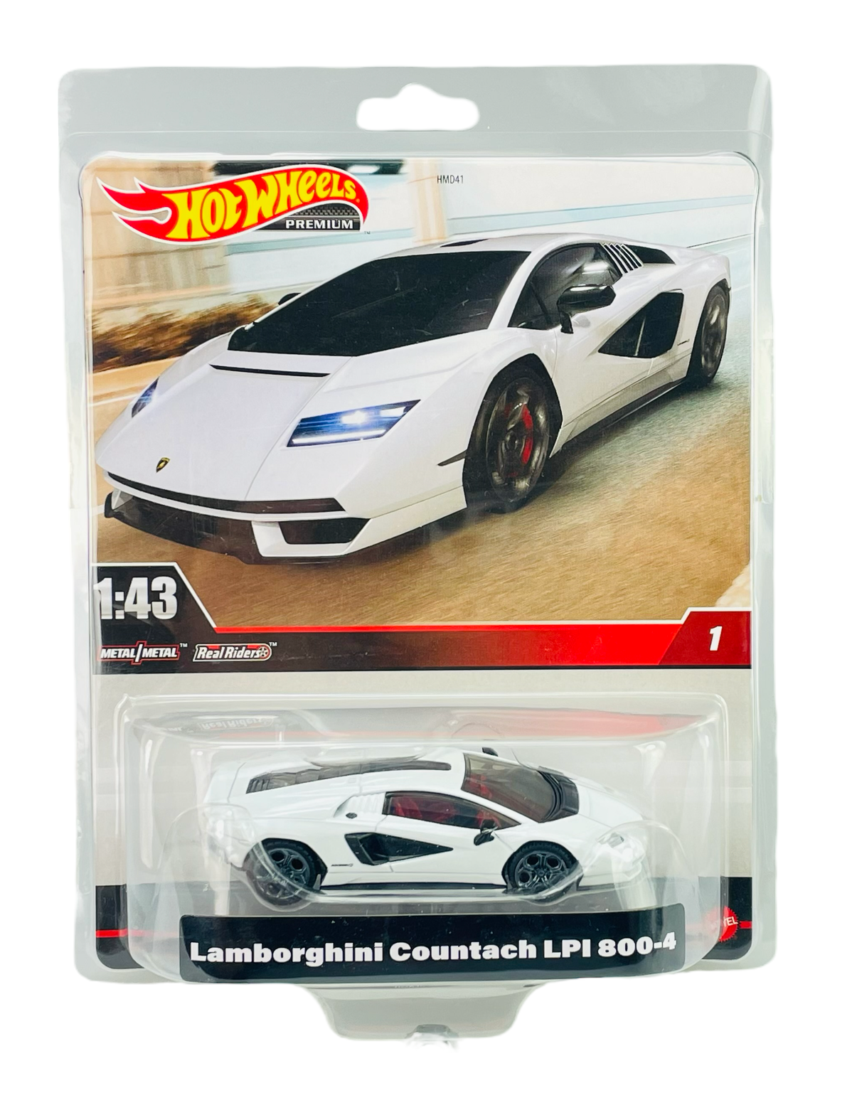 Opakowanie z modelem samochodu Hot Wheels Premium w skali 1:43, przedstawiające biały Lamborghini Countach LPI 800-4. Na opakowaniu widoczne są napisy: \'Hot Wheels Premium\', \'1:43\', \'Metal/Metal\', \'Real Riders\' oraz \'Lamborghini Countach LPI 800-4\'.